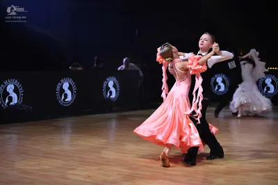 Dancesport competitor: Male dancer: white long-sleeved shirt, black trousers, and black dance shoes