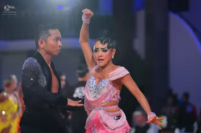 Dancesport competitor: Male dancer: black long-sleeved shirt with silver sequin embellishments on the s
