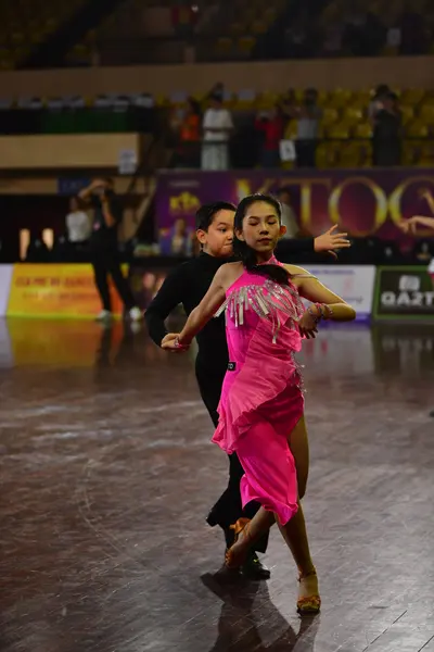 Dancesport competitor: Male dancer: black long-sleeved shirt and black trousers