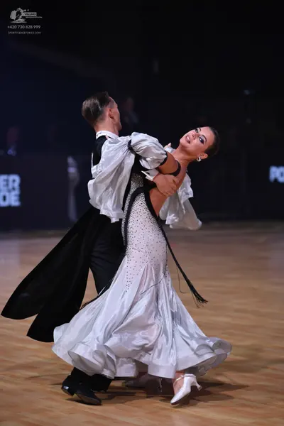 Dancesport competitor: Male dancer: black tailcoat, white shirt with a high collar, black trousers, and