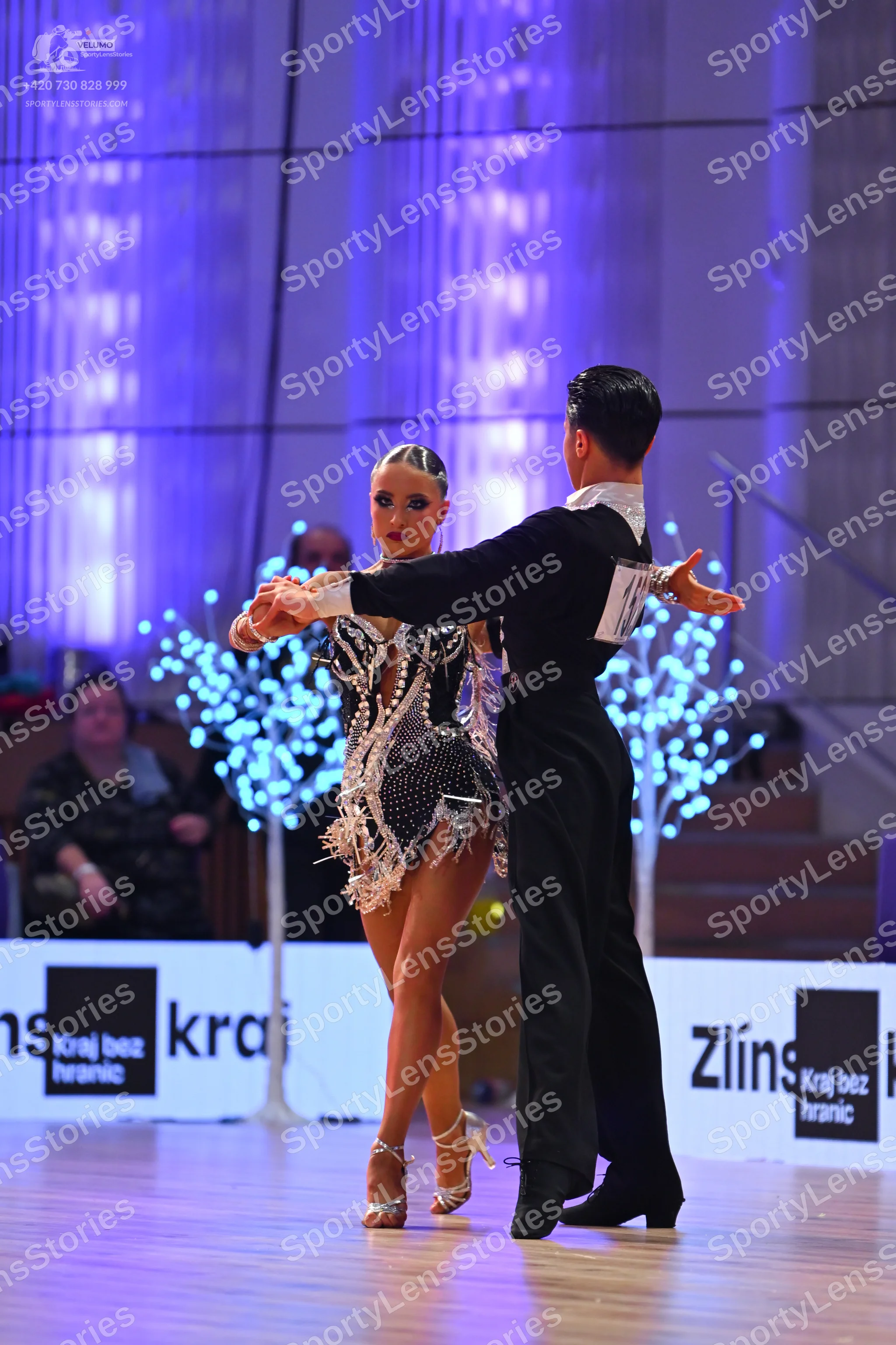 Dancesport competitor: Female dancer: short black latin dress heavily embellished with silver sequins a