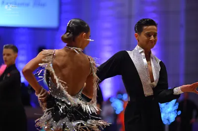 Dancesport competitor: Female dancer: black Latin dress with silver sequins and fringe