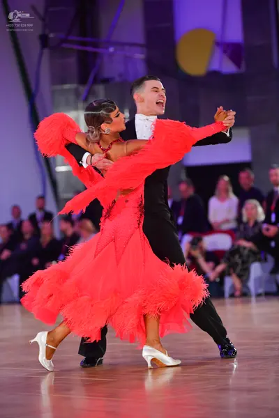 Dancesport competitor: Male dancer: black suit with a white shirt and white bow tie