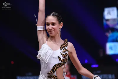 Dancesport competitor: Female dancer: white latin dress with leopard print pattern and pearl embellishm
