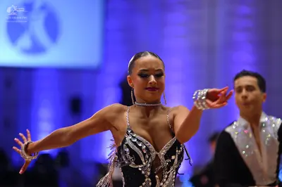 Dancesport competitor: Male dancer: black Latin dance shirt with silver/white sequin embellishments