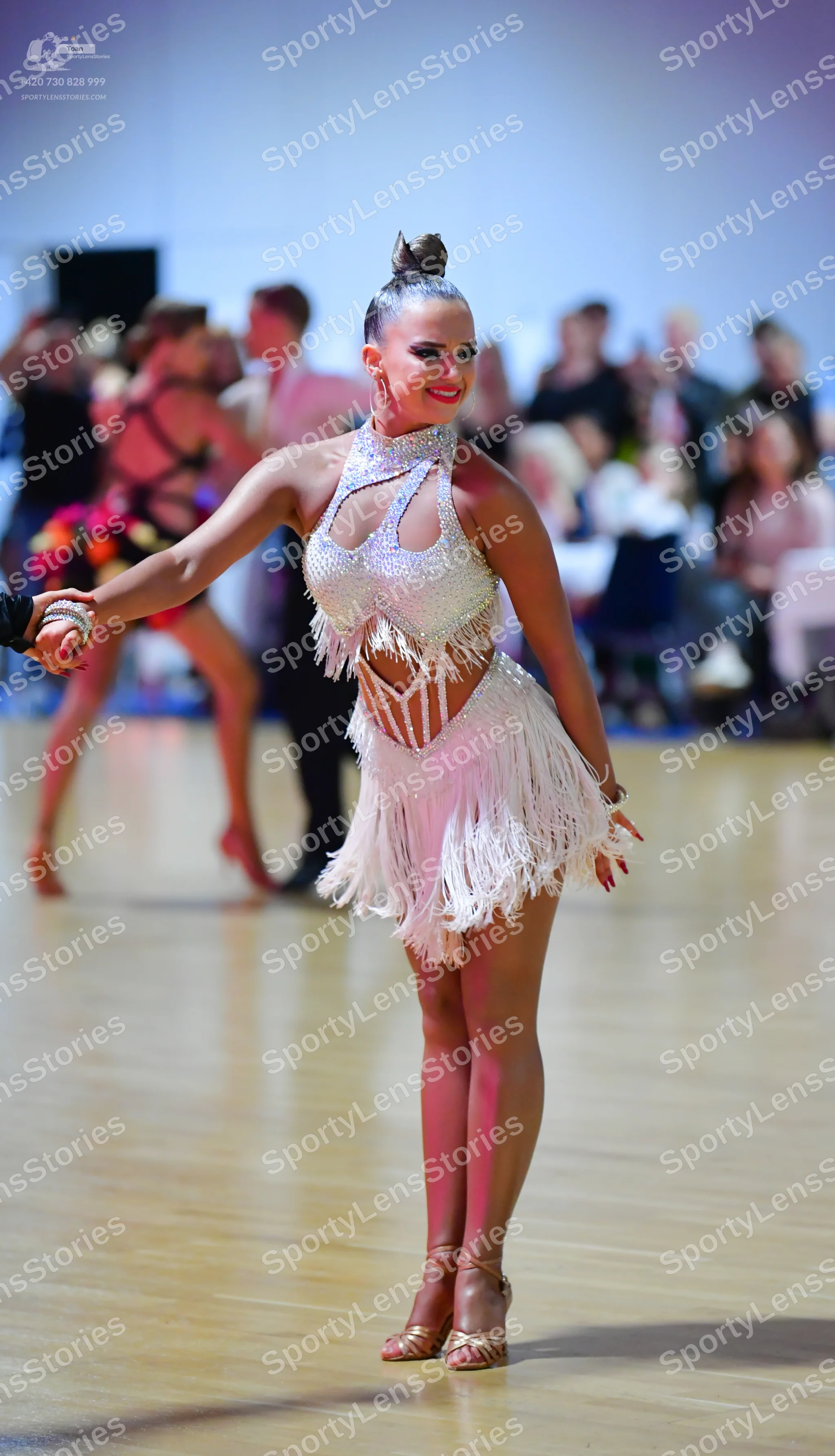 Dancesport competitor: Female dancer: white/silver latin dance dress with sequins, halter neck, cutouts