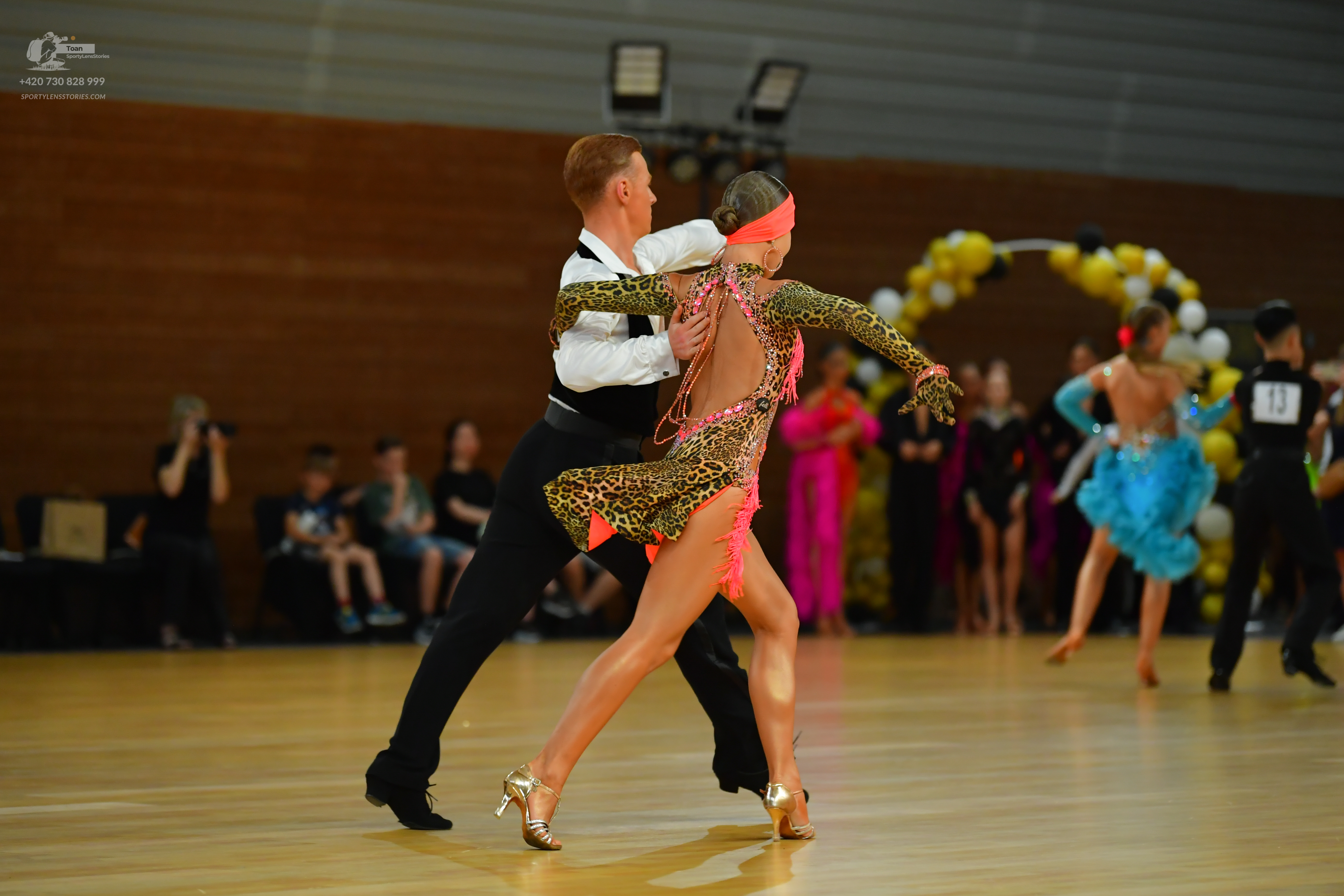 Dancesport competitor: ** Black tail suit with white sequin lapels and cuffs