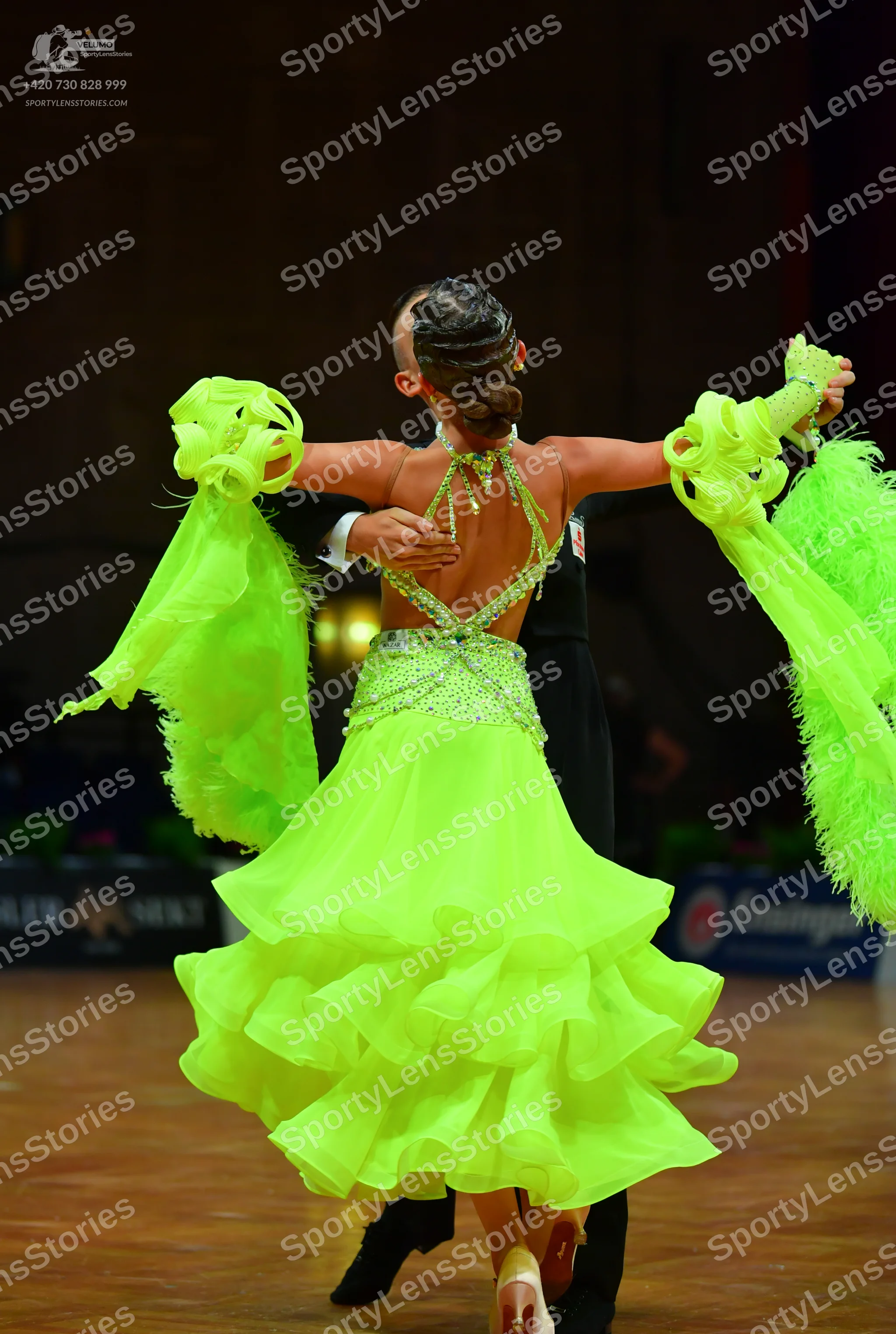 Dancesport competitor: Female dancer: bright lime green Latin dress with a sequined/rhinestone bodice a