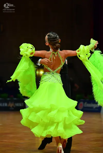 Dancesport competitor: Female dancer: bright lime green Latin dress with a sequined/rhinestone bodice a