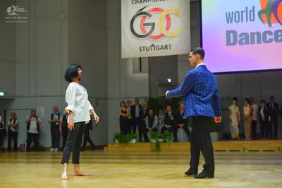 Dancesport competitor: Male dancer: blue patterned blazer with black trousers
