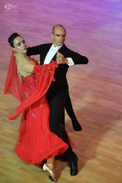 Dancesport competitor: Male:** Black tail suit with satin lapels and black patent leather shoes