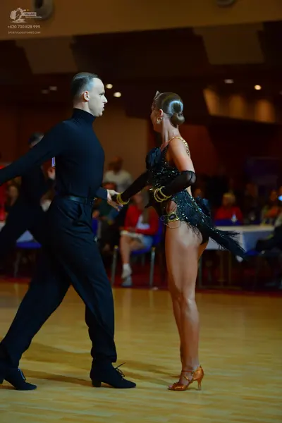 Dancesport competitor: Male dancer: black long-sleeved turtleneck and black trousers