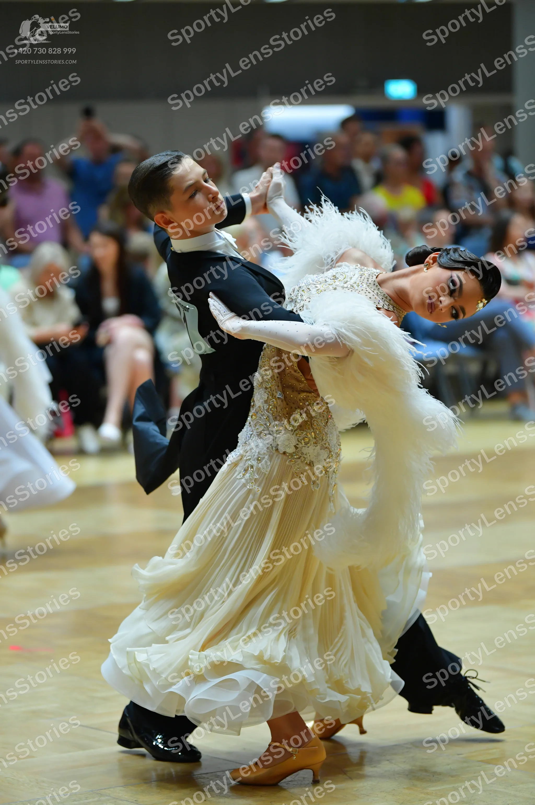 Dancesport competitor: Male dancer: black ballroom tailcoat with white lapels, black trousers, and blac