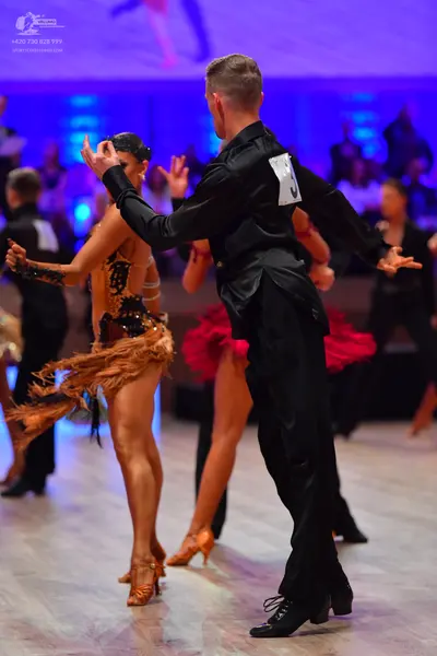 Dancesport competitor: Male dancer: black long-sleeved shirt and black trousers