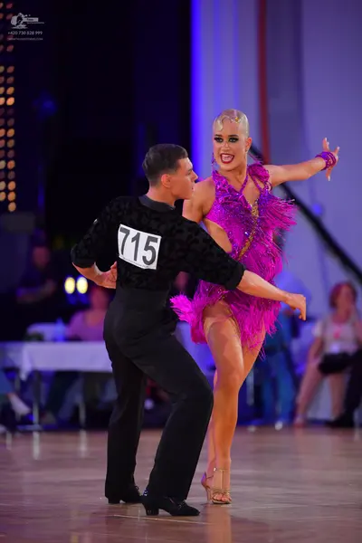 Dancesport competitor #715: Male dancer: black long-sleeved textured shirt and black trousers
