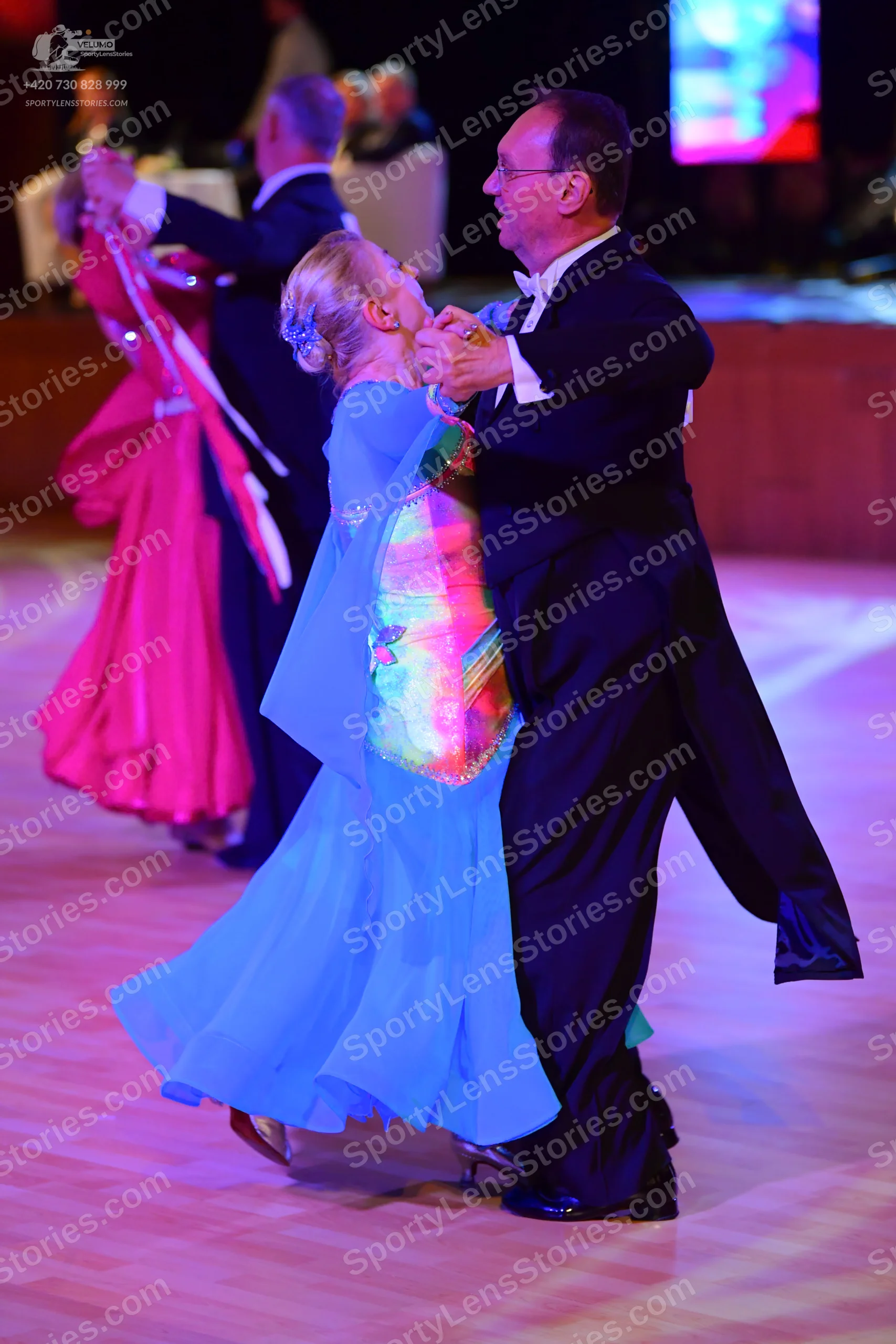 Dancesport competitor: ** Red Latin Dress
*   **Color:** Primarily deep red