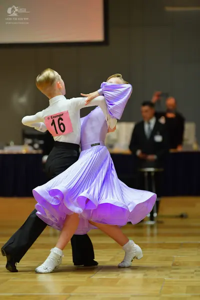 Dancesport competitor #16: Male dancer: white long-sleeved shirt and black trousers