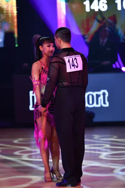 Dancesport competitor: Male dancer: black long-sleeved shirt with sheer mesh fabric on the upper chest 