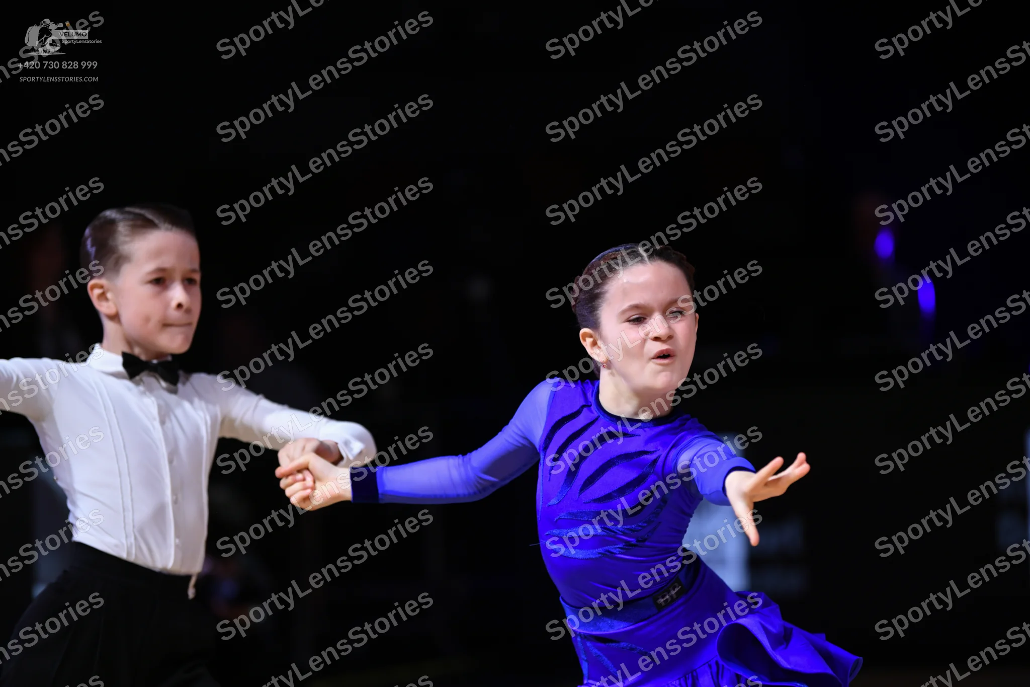 Dancesport competitor: Male dancer: white long-sleeved shirt with a black bowtie and black trousers