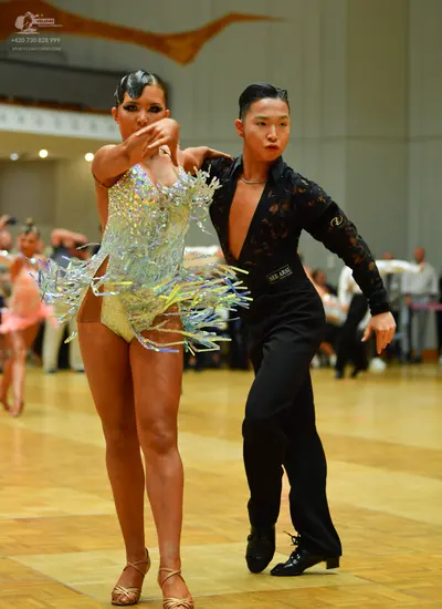 Dancesport competitor: Female dancer: silver Latin dance dress with sequins and long fringe