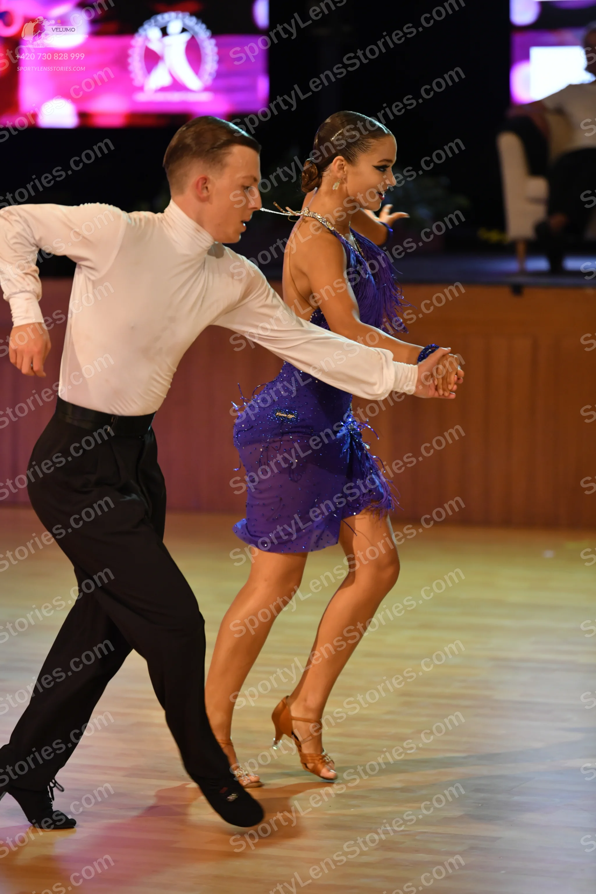 Dancesport competitor: Male:** Black fitted suit with sequin lapels and a black tie