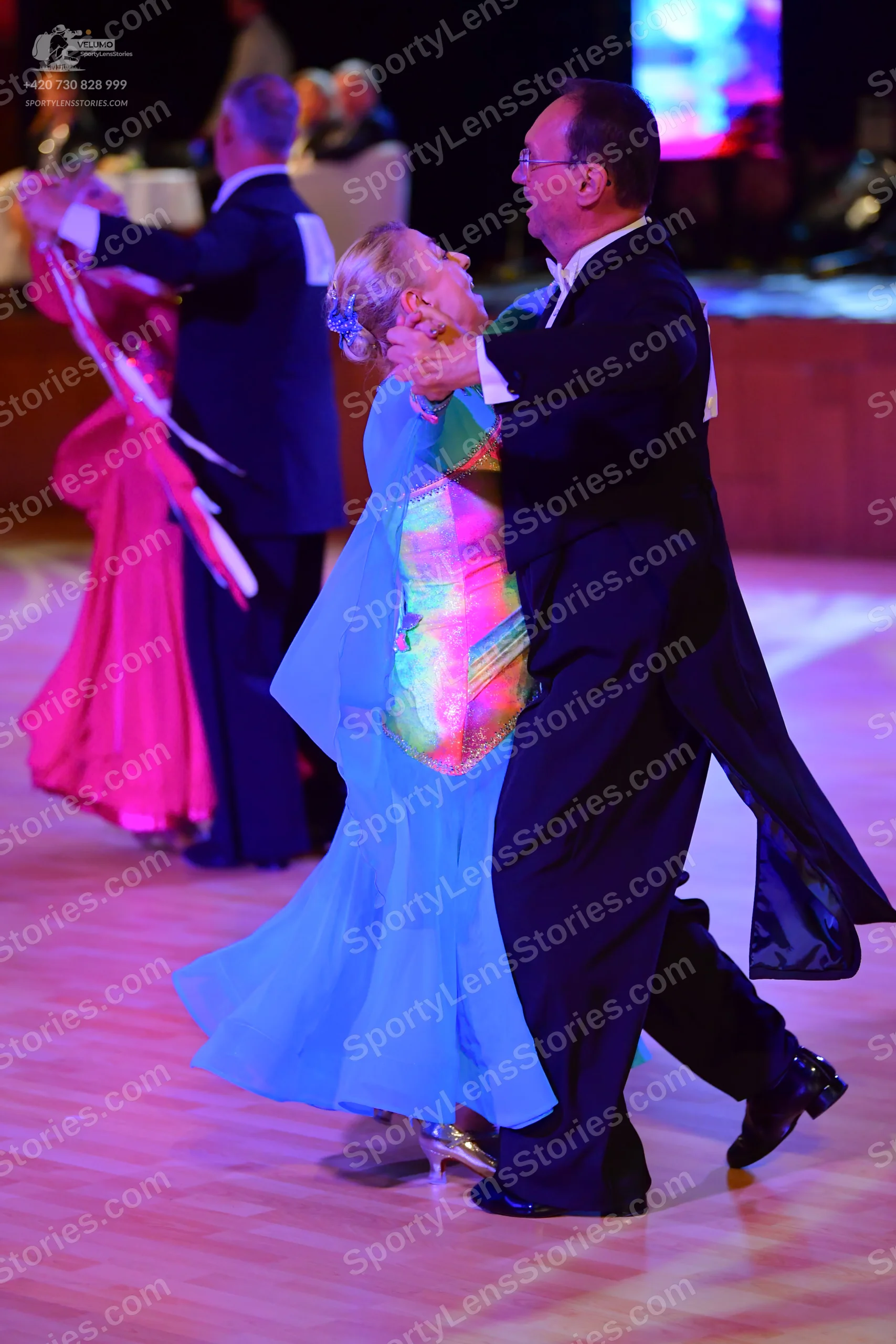 Dancesport competitor: ** Red Latin dress
*   **Fabric:** Appears to be a satin or satin-blend fabric, 