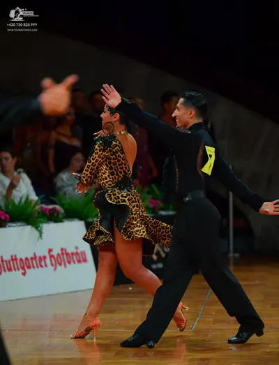 Dancesport competitor: Male dancer: black long-sleeved shirt and black trousers with black dance shoes