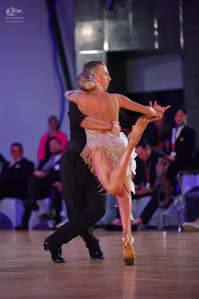 Dancesport competitor: Male dancer: black long-sleeved shirt and black trousers