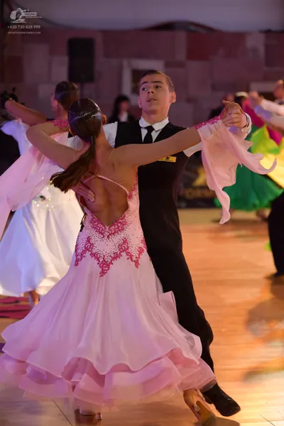 Dancesport competitor: Male dancer: black suit, white shirt, and black tie