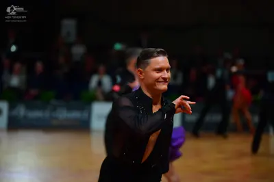 Dancesport competitor: Male dancer: black, long-sleeved, sheer top with small rhinestones