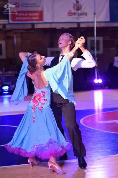 Dancesport competitor: Male dancer: white long-sleeved shirt, black waistcoat, and black trousers