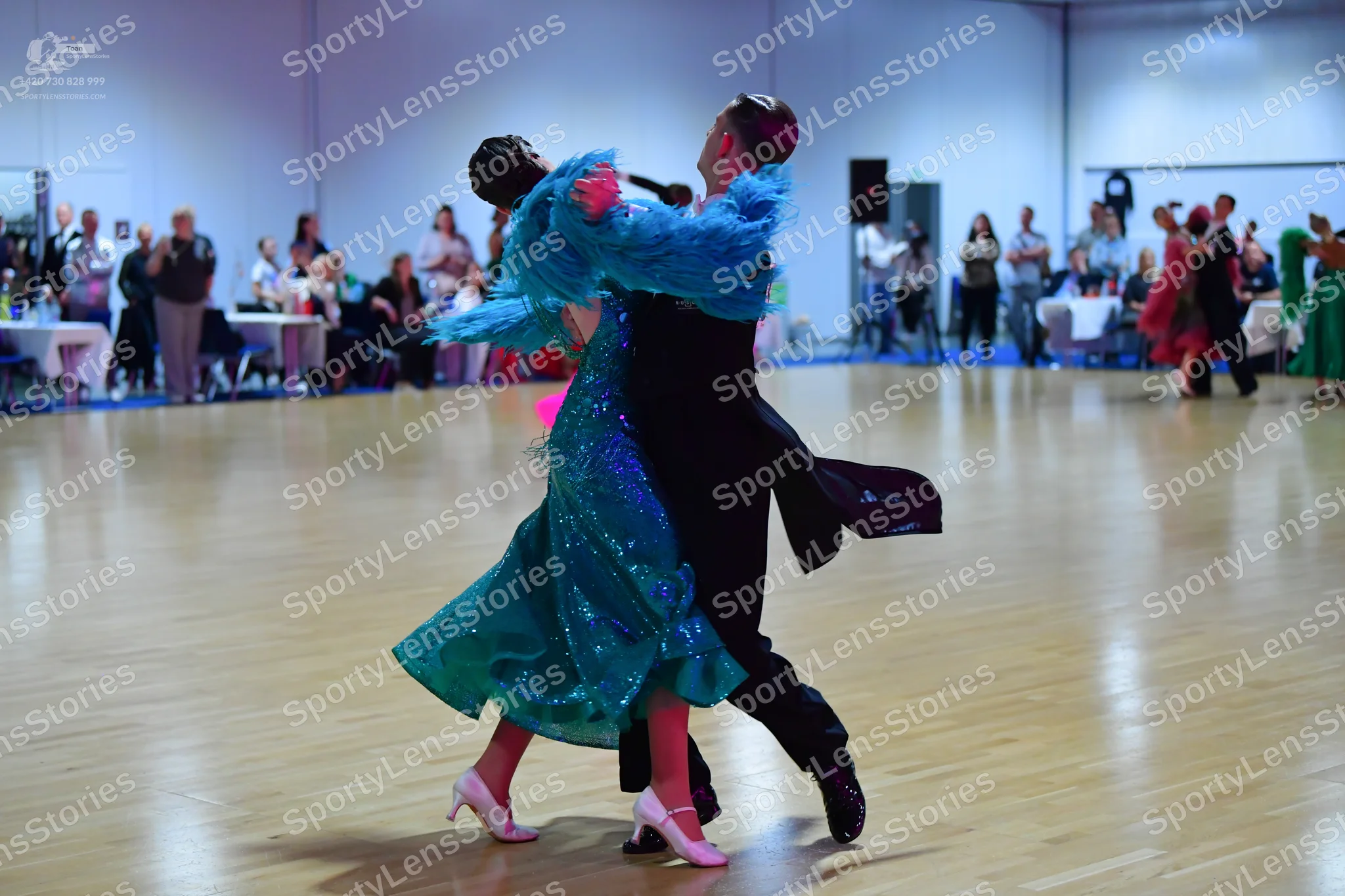 Dancesport competitor: Female dancer: teal/turquoise sequined ballgown