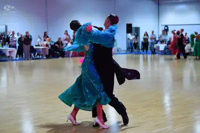 Dancesport competitor: Female dancer: teal/turquoise sequined ballgown