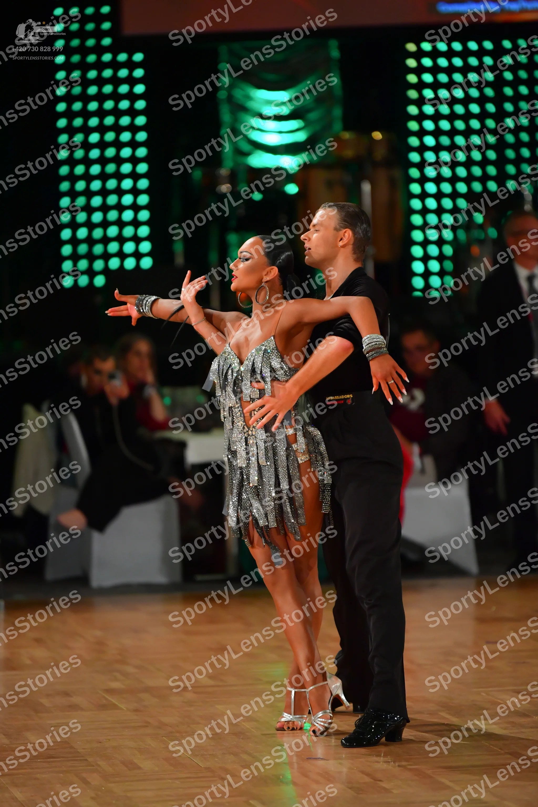 Dancesport competitor: Female dancer: silver sequined Latin dress with long fringe, silver high-heeled