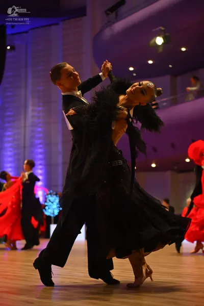 Dancesport competitor: Male dancer: black suit with a white shirt