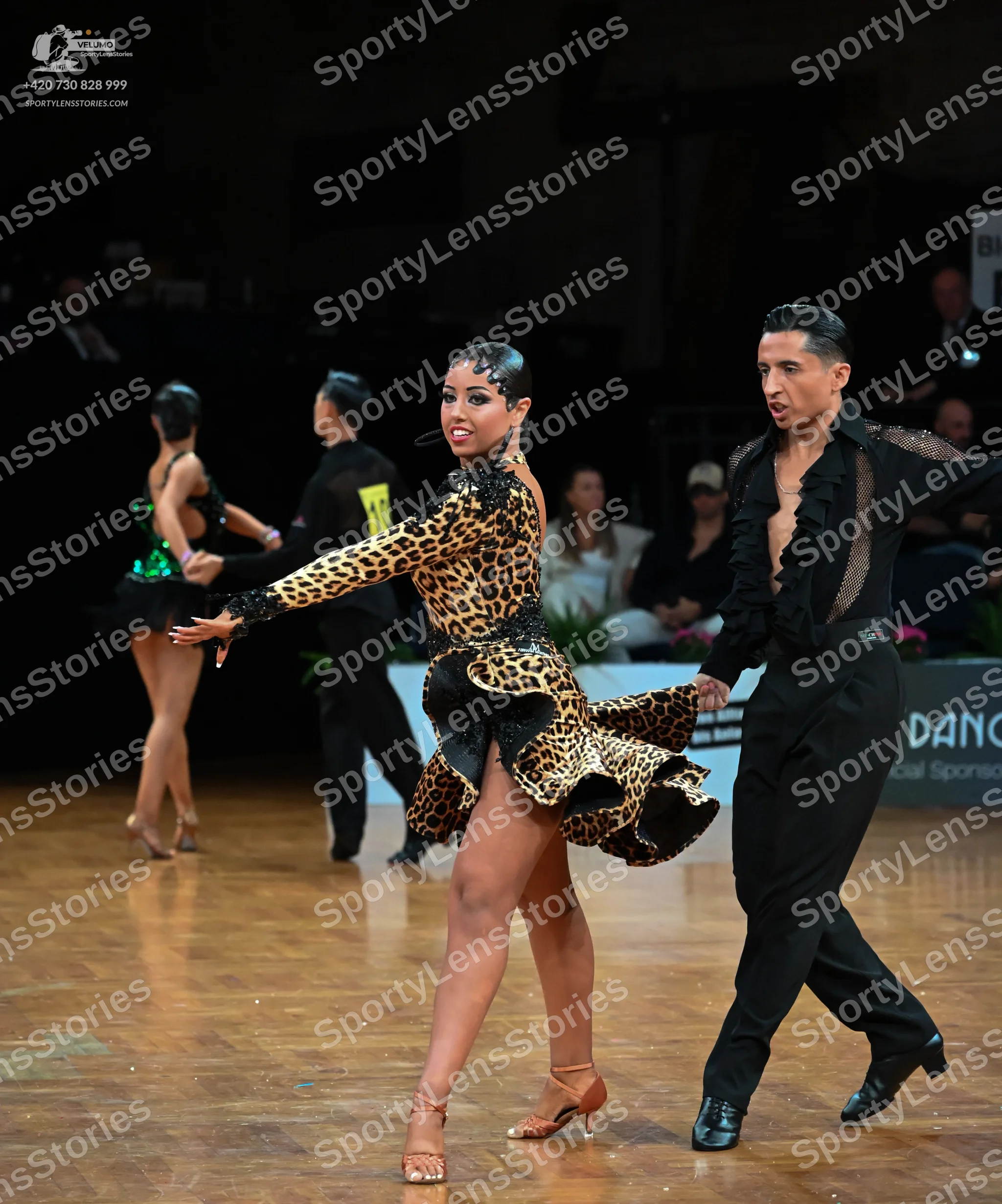 Dancesport competitor: Male dancer: black latin dance shirt with a textured or sequined front and black