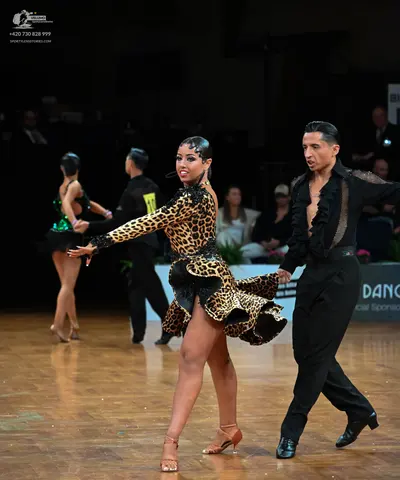 Dancesport competitor: Male dancer: black latin dance shirt with a textured or sequined front and black