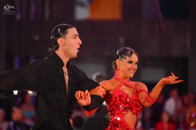 Dancesport competitor: Male dancer: black ruffled long-sleeved shirt