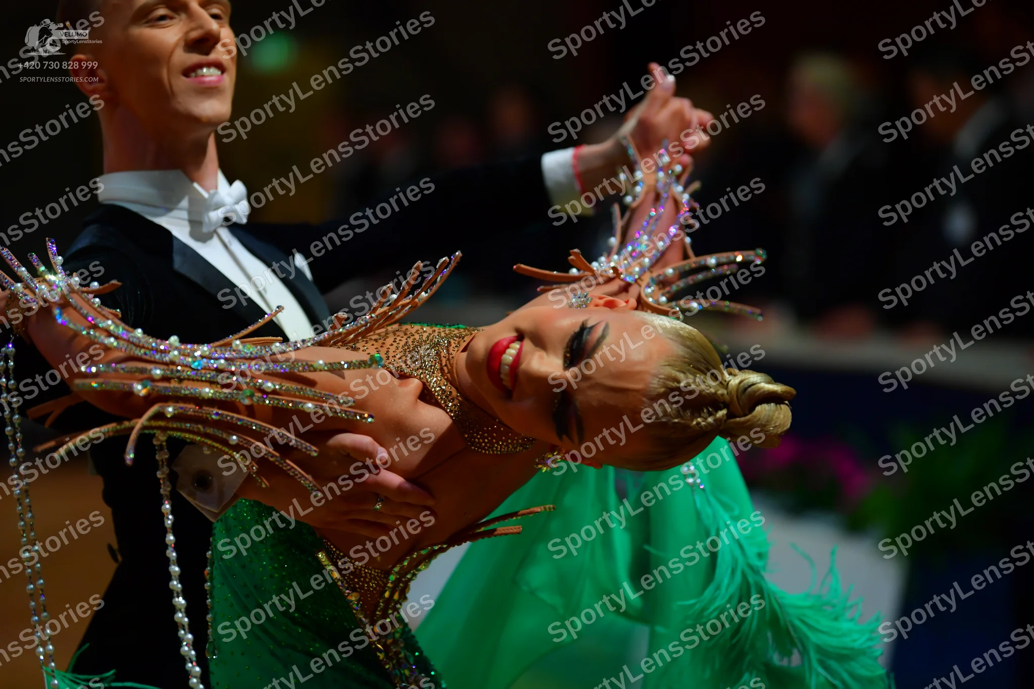 Dancesport competitor: Male dancer: black tuxedo with a white shirt and white bow tie