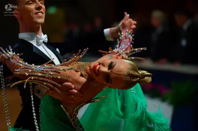 Dancesport competitor: Male dancer: black tuxedo with a white shirt and white bow tie