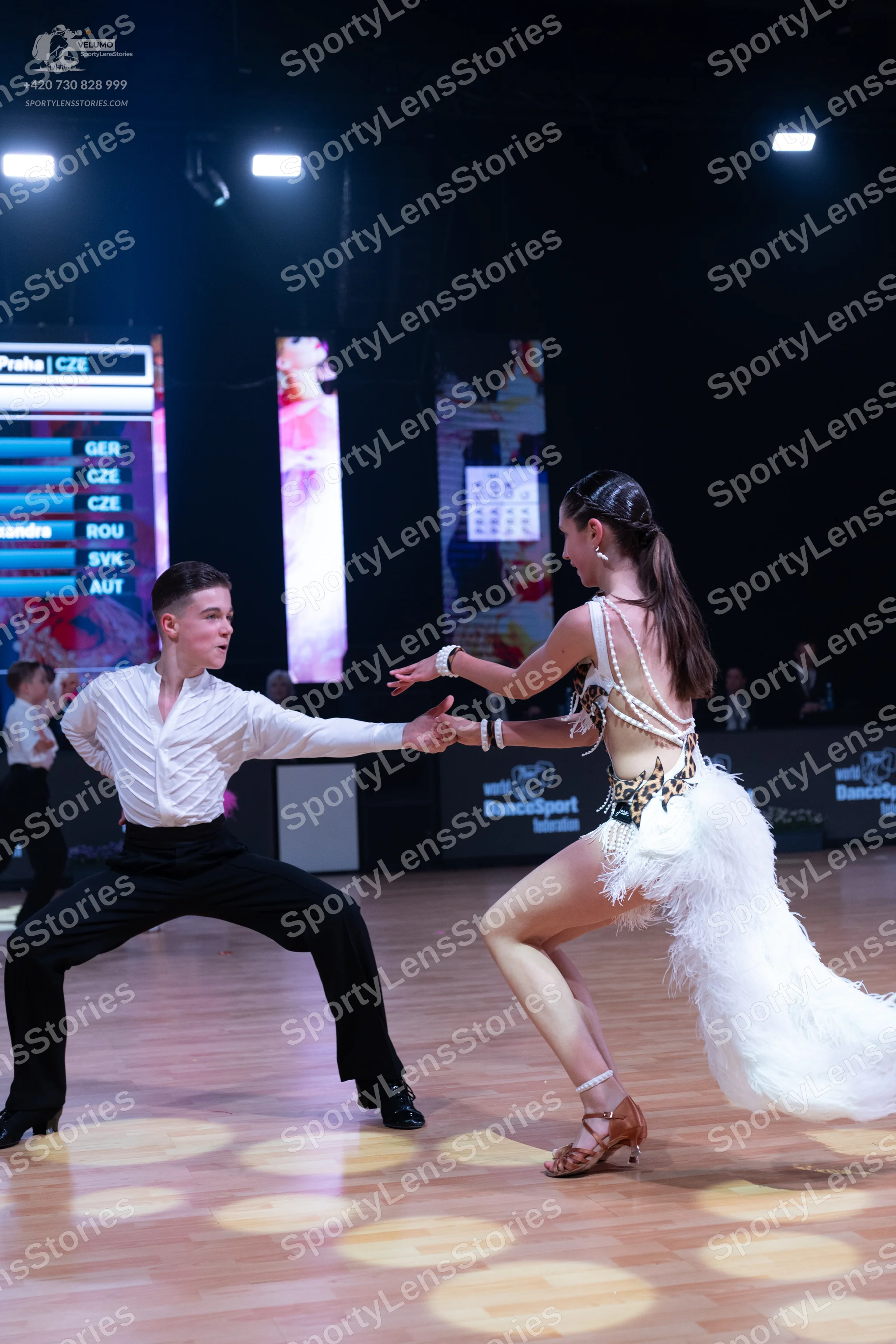Dancesport competitor: Male dancer: white long-sleeved textured shirt and black trousers
