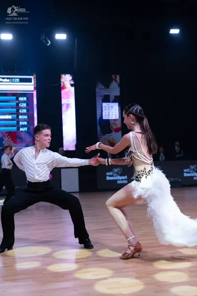 Dancesport competitor: Male dancer: white long-sleeved textured shirt and black trousers