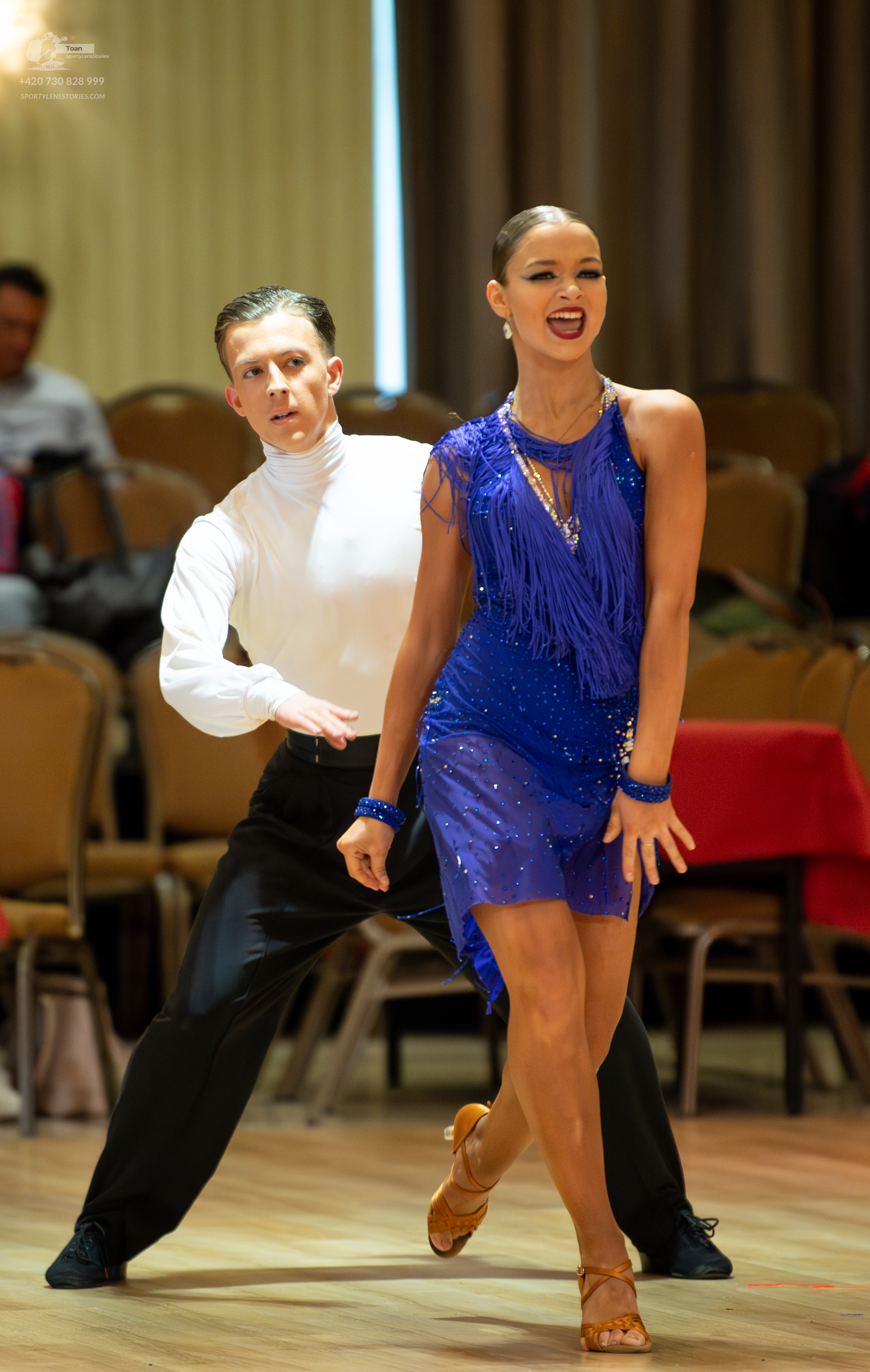 Dancesport competitor: Male dancer: white long-sleeved turtleneck and black trousers