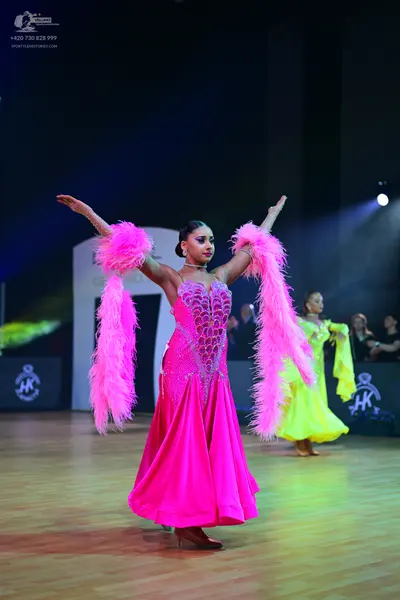 Dancesport competitor: Female dancer 1: pink ballgown with a sparkly, embellished bodice and a satin sk