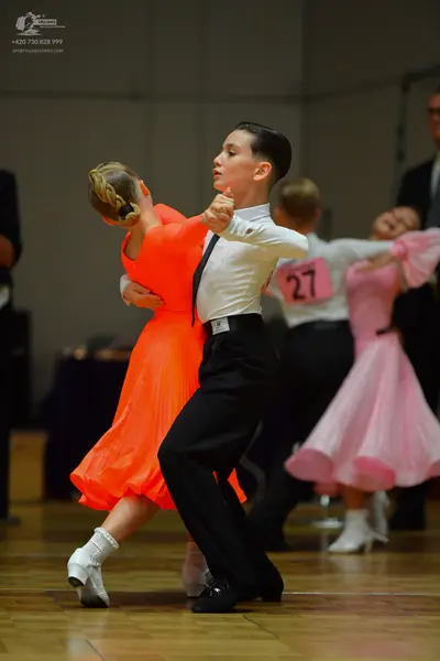Dancesport competitor #27: Male dancer: white long-sleeved shirt, black necktie, and black trousers