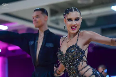 Dancesport competitor: Male dancer: black shirt with a deep V-neckline