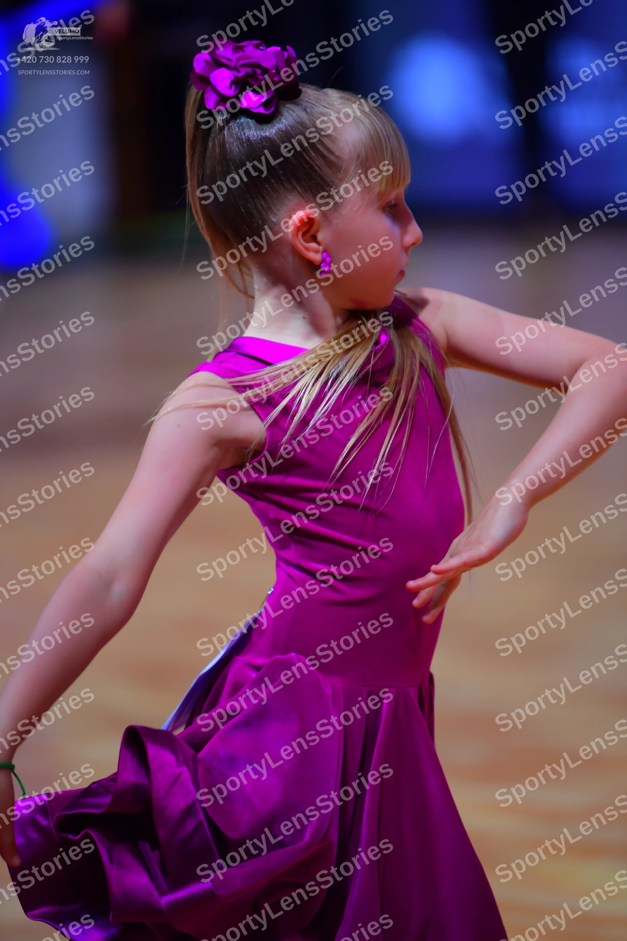 Dancesport competitor: Female dancer: magenta satin latin dress with a voluminous skirt and a matching 
