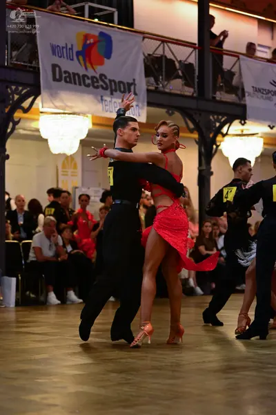 Dancesport competitor: Male dancer: black long-sleeve shirt and black trousers