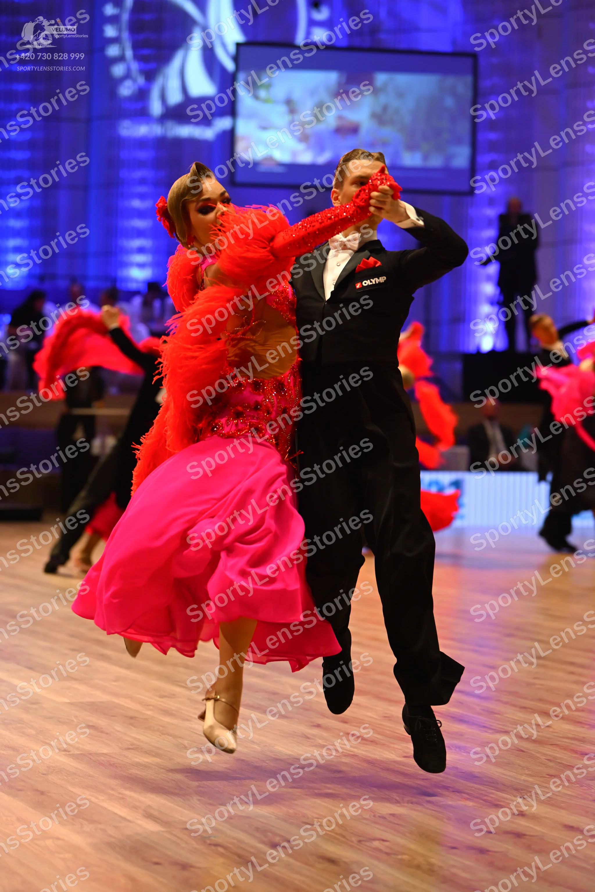 Dancesport competitor: Male dancer: black suit, white shirt, and a light-colored bow tie