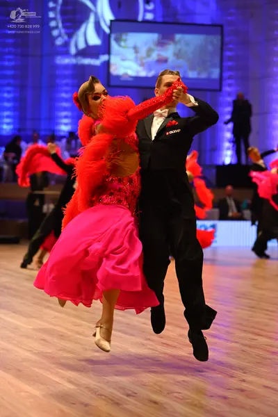 Dancesport competitor: Male dancer: black suit, white shirt, and a light-colored bow tie